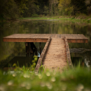 Bridge leads to rustic dock on lake