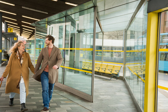 Couple Walks Together at Bus Station in Liverpool