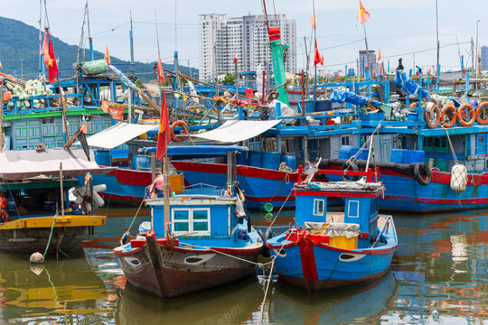 Colorful fishing boats moored next to one another in a coastal harbor