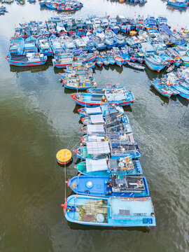 Colorful fishing boats tied closely together in abstract patterns