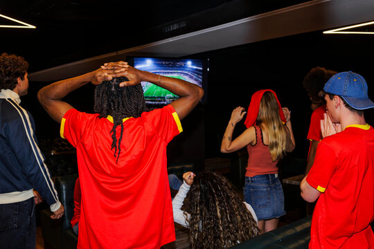 Frustrated football fans watching live sport competition