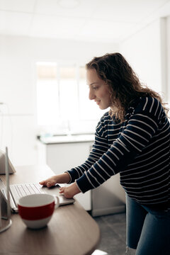 Woman with disability typing on laptop working comfortably