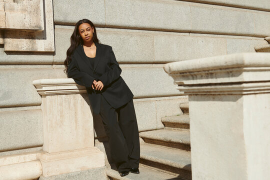 Woman on stair case in fashion outfit