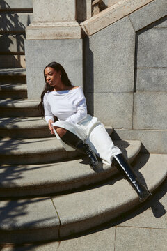 Woman on stair case in fashion outfit