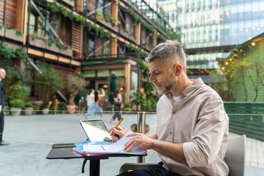 Man Works Outside in City Setting 