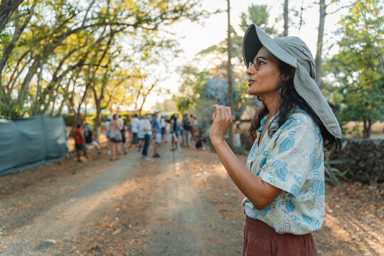 A tour guide with her group exploring a trail