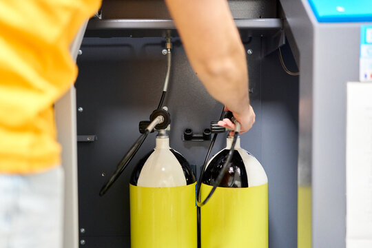 Diver filling scuba tanks at dive center station