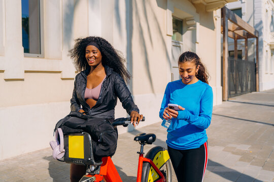 Two women walk through the city after sports