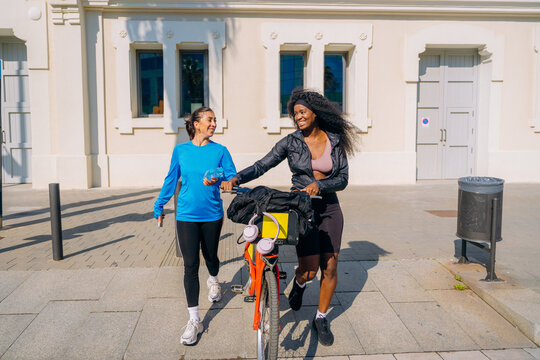 Two women walk through the city after sports