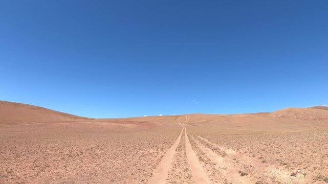Driving along a country road in Altai desert and semi-desert environment.
