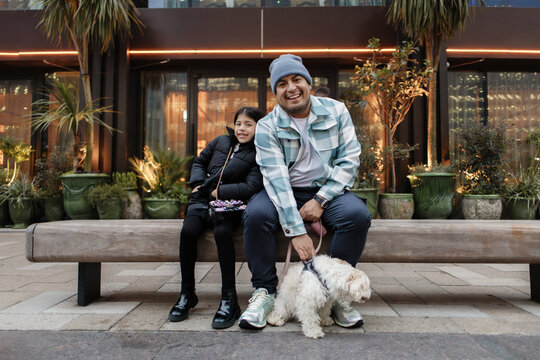 Father and daughter enjoying city life with pet dog