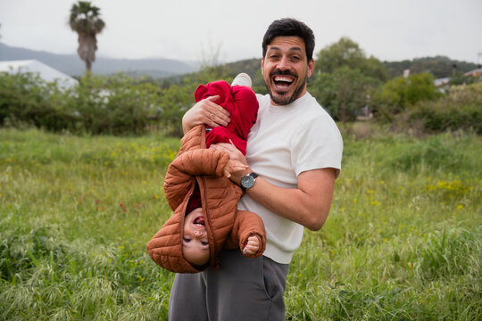 Father holding son upside down