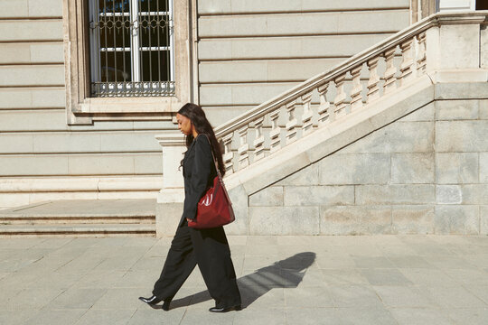 Woman wearing back on urban street 