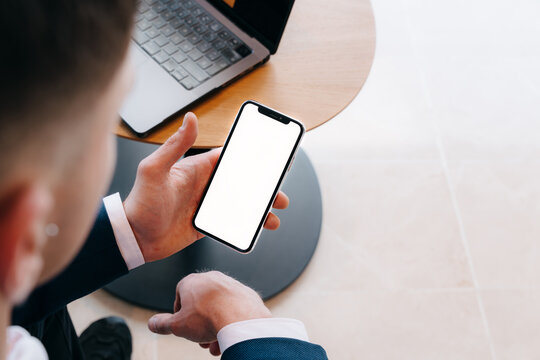 Hand holding white screen phone
