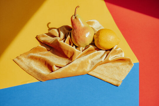 Fruits on a silk cloth with colorful background in daytime