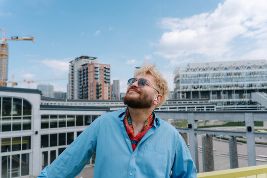 Stylish man looking up in the city