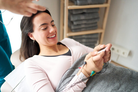 Woman smiling receiving neurostimulation therapy