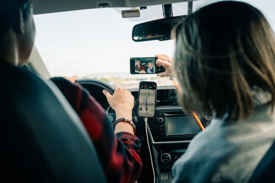 Group Takes Selfie While Driving on a Sunny Day in a Car
