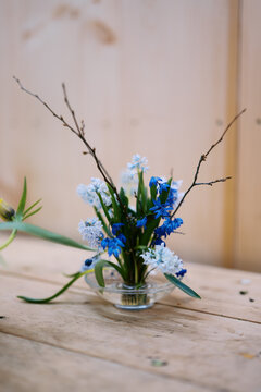 close up of spring bulb flowers arranged on pin frog with water bowl