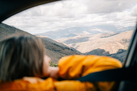 Person Enjoys Mountain View From Car Window in a Scenic Location