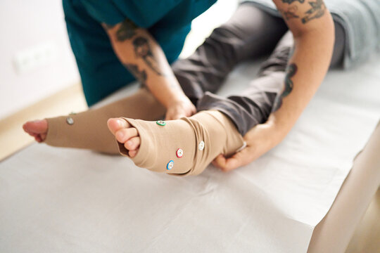 Physiotherapist applying neurostimulation electrodes