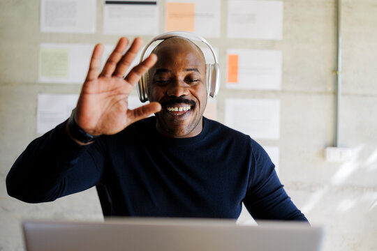 Man waving during a video call meeting