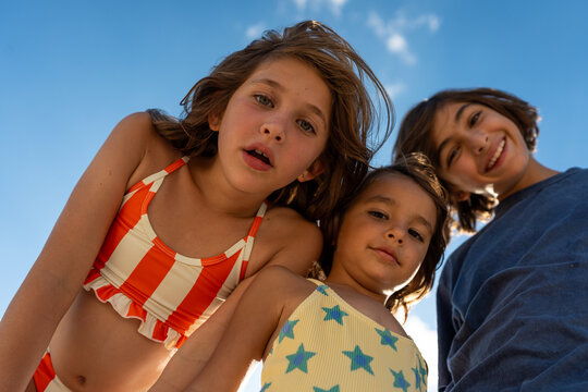 Sunlit Children Portrait by the Sea