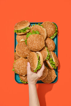 Hand Picking a Hamburger. Fast, finger food.