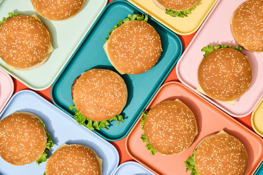 Burgers on Colorful Trays. Finger, fast food background. 