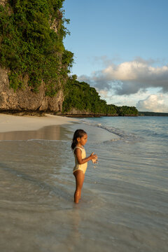 Child standing in clear ocean water