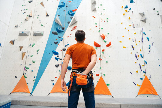 Man preparing for indoor rock climbing adventure