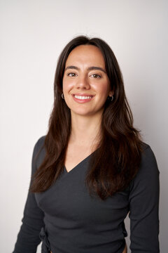 Woman smiling, looking at camera with professional expression