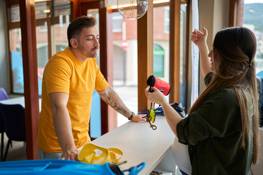 Customer consulting dive equipment with shop employee