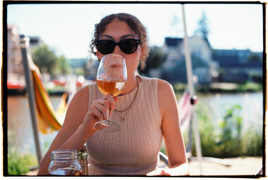 Enjoying a Drink by the Water in Summer During a Sunny Afternoon