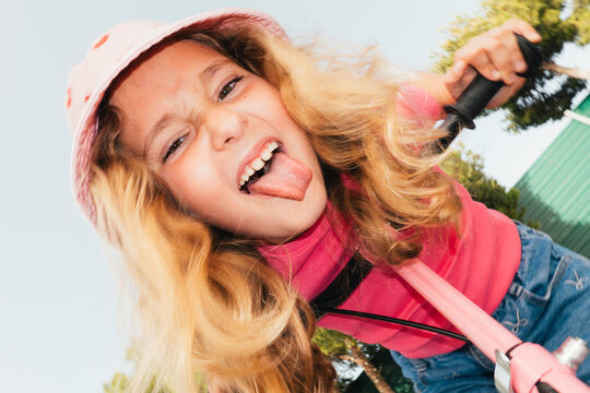 Young girl looking down in sunlight