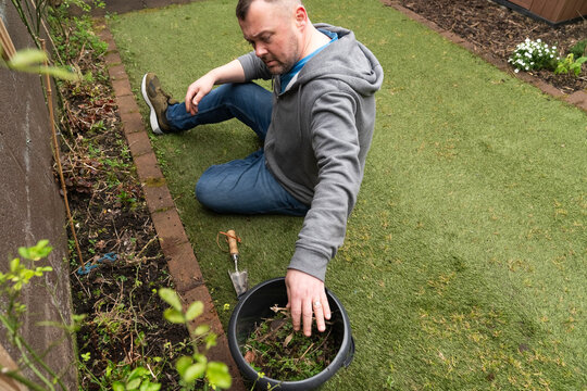 Man Gathers Weeds and Prepares to Plant Seeds in Ireland During Spring