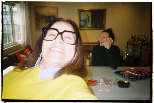 Friends Take Selfies in a Kitchen During a Casual Get-Together