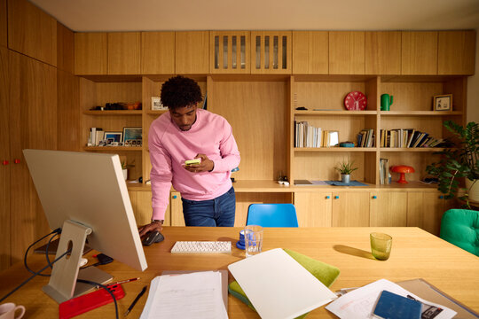 Busy man stands in his home office