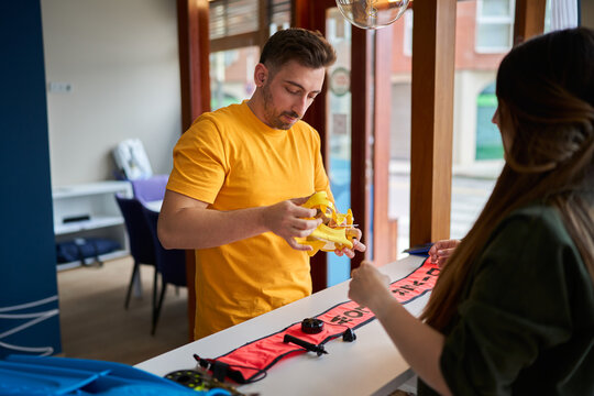 Man and woman shopping dive gear in center