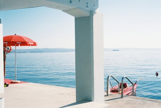 Seaside Pier with Red Umbrella