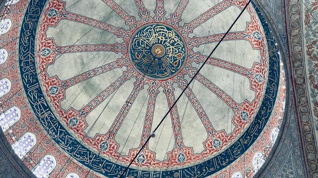 Magnificent painted dome with ancient arabic calligraphy at Blue Mosque in Istanbul, Turkey. Detailed Iznik patterns and ottoman architecture, perfect for holy Ramadan and Eid holiday background.