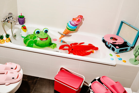 a bathroom with inflatables and a record player playing a pink vinyl