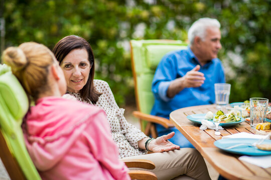 Family enjoying outdoor lunch and conversation