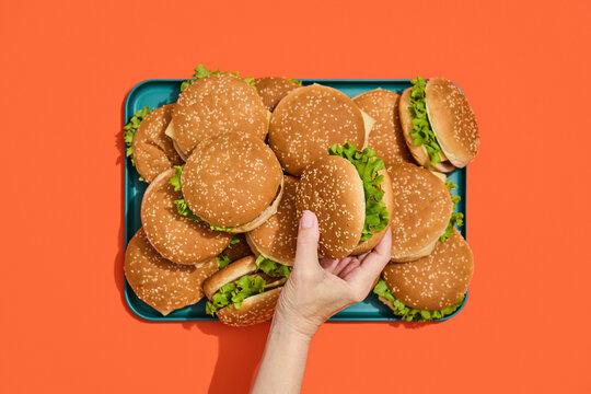 Hand Picking a Hamburger. Fast, finger food.