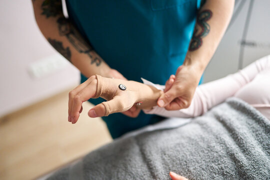 Patient receiving hand neurostimulation therapy