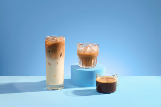 Three refreshing coffee drinks with ice on a bright blue background