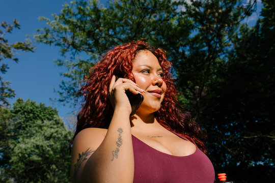 Active woman answers a cell phone call during a morning workout