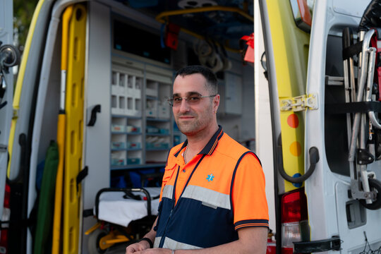 Paramedic standing in front of ambulance