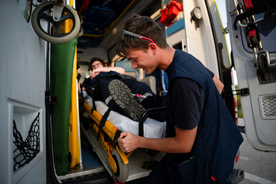 Emergency medical team assisting patient on stretcher