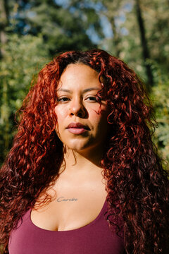 A natural light close portrait captures a curvy woman